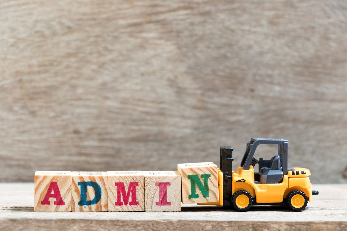 Toy forklift hold letter block N in word admin on wood background